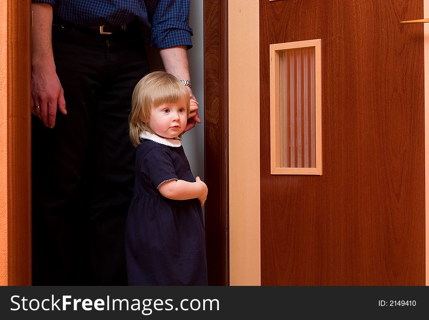 Cute little girl with blond hair holding her father's hand. Cute little girl with blond hair holding her father's hand