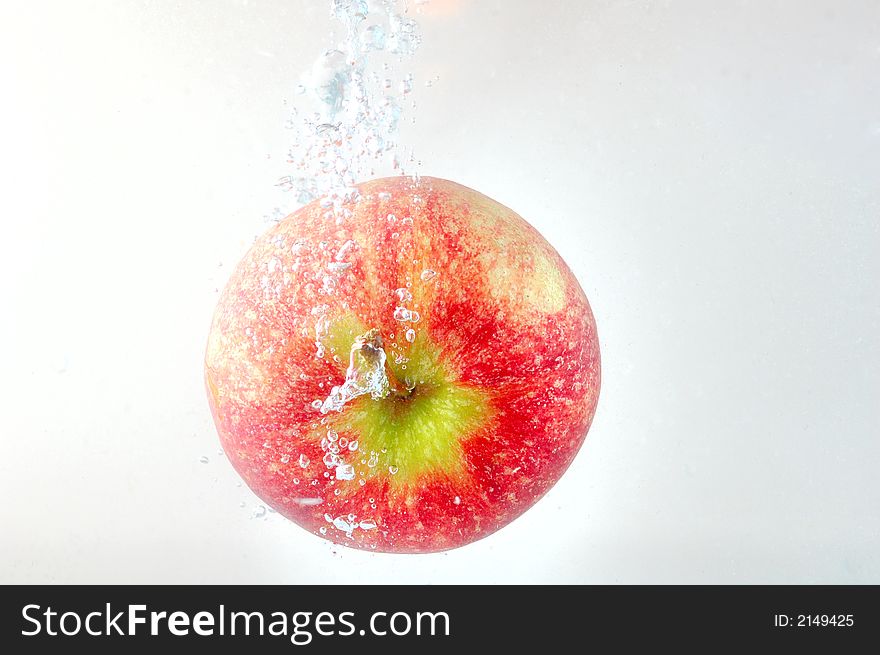 Apple thrown into water. High speed photography. Apple thrown into water. High speed photography.