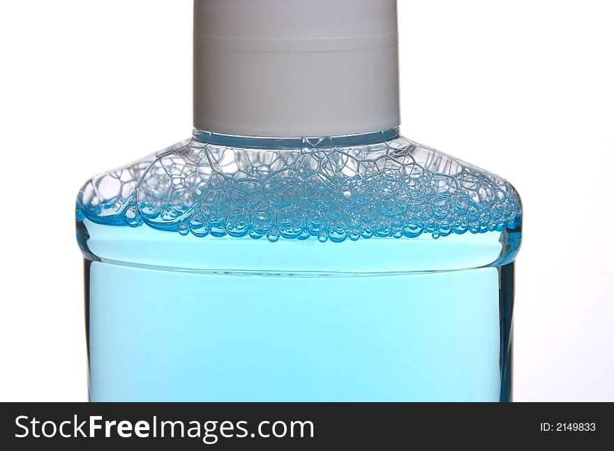 Made a foam blue cleaning liquid in a plastic vessel on a white background