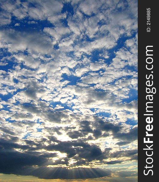 Evening sun shines through the ragged clouds. Evening sun shines through the ragged clouds