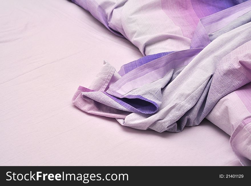 Messy bedclothes in violet color