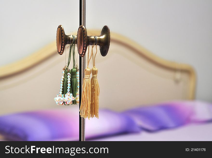 Bed reflected in a mirror door with doorknobs. Bed reflected in a mirror door with doorknobs