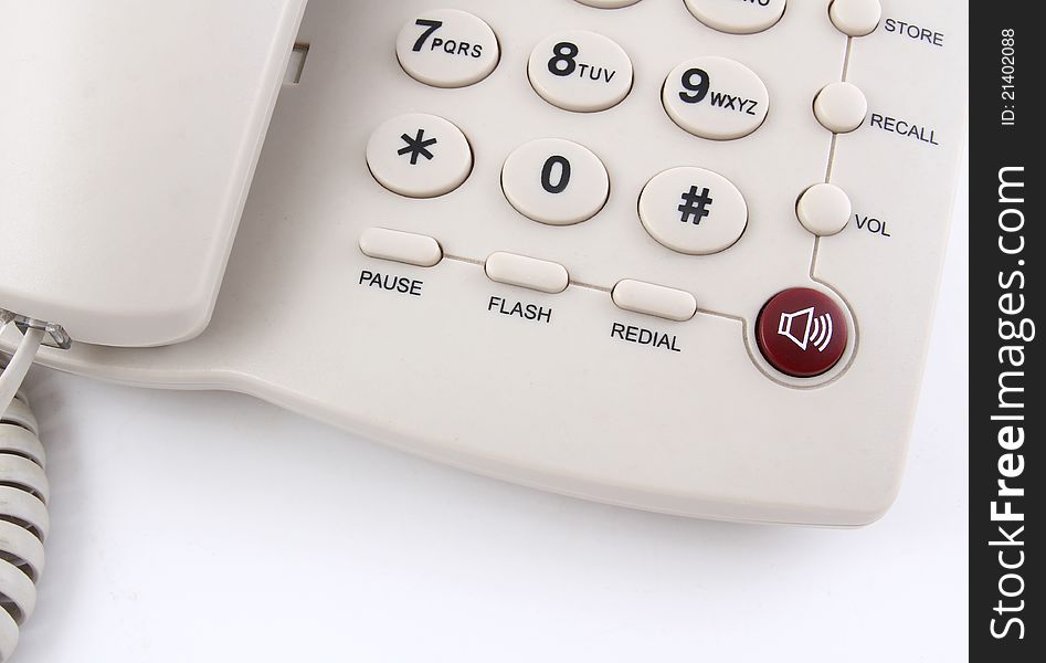 Closeup of a white office telephone on white background