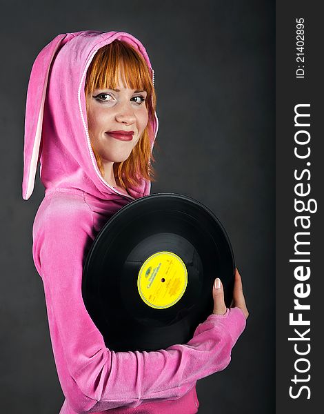 Cute young pretty girl in stylish pink wear with gramophone record. Cute young pretty girl in stylish pink wear with gramophone record