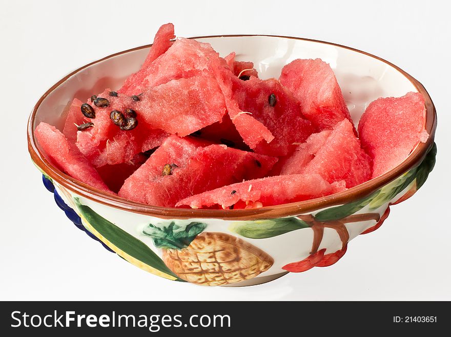 Large coloured basin with watermelon slices without crust isolated on white background