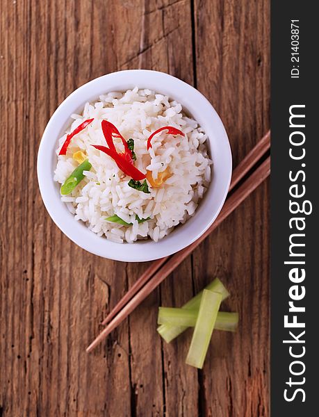 Small bowl of cooked white rice and chopsticks. Small bowl of cooked white rice and chopsticks