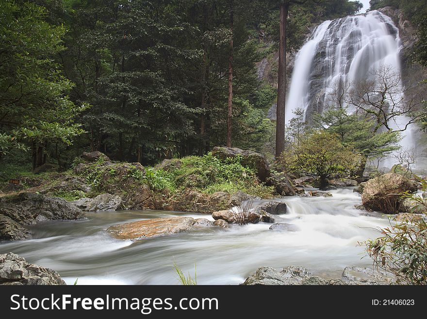 Waterfall in Thailand with green nature and clear water.