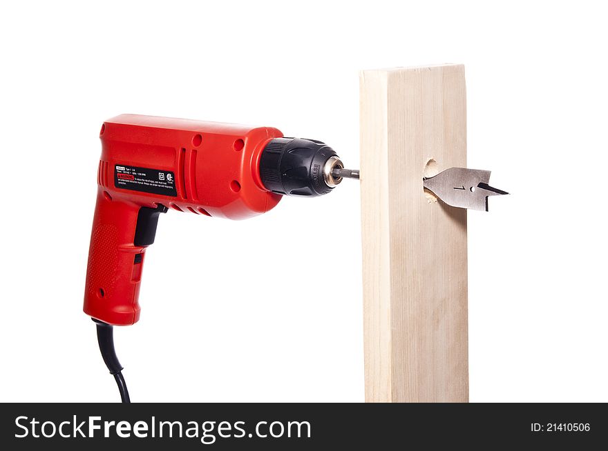 Drilling a hole through a wooden board with 1 inch drill bit. Drilling a hole through a wooden board with 1 inch drill bit