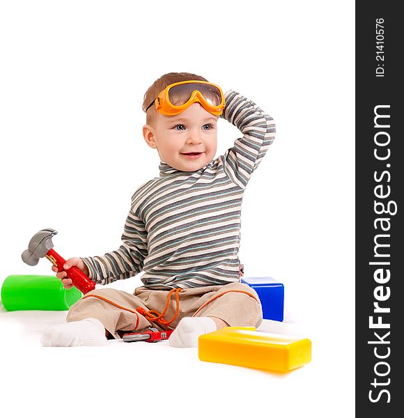 Little boy with building blocks and tools studio shot