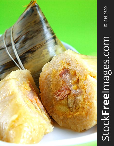 Traditional Chinese rice puddings on green background