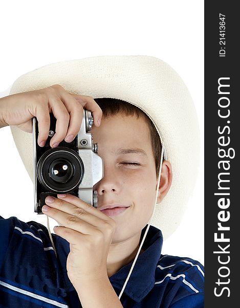 The young teenager in a white hat holds photographs, holding the camera before itself. The young teenager in a white hat holds photographs, holding the camera before itself