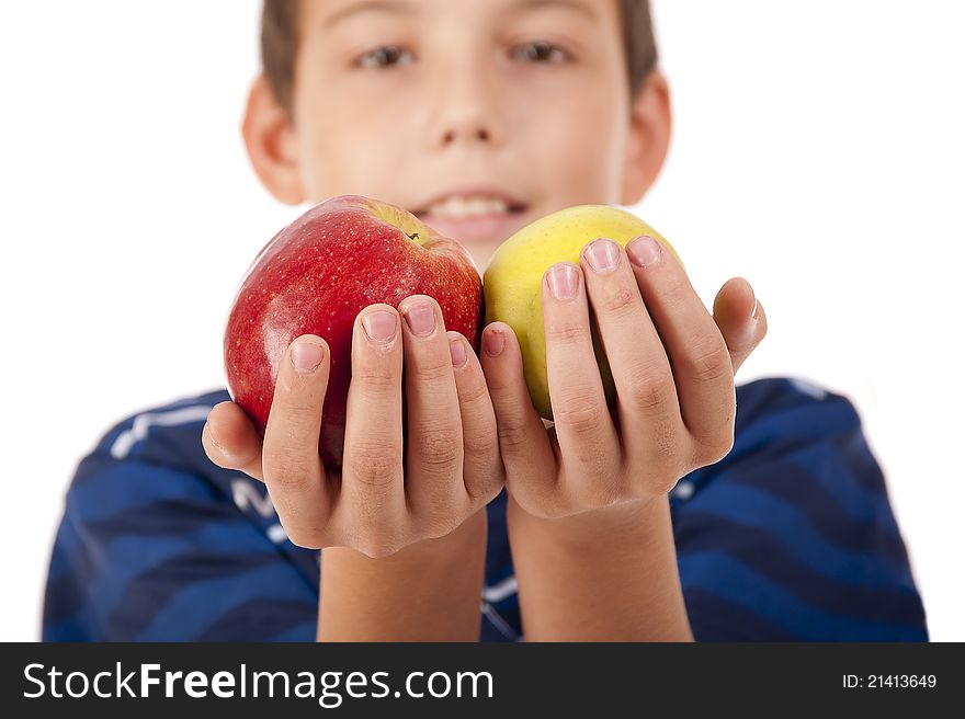 The teenager  holds two apples