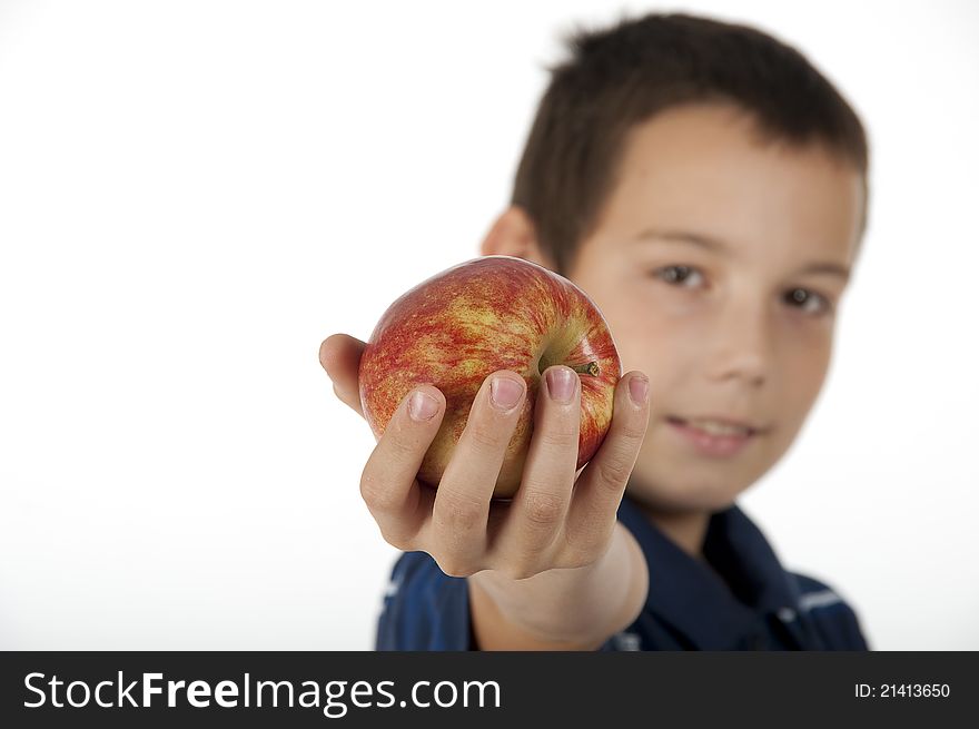 The young eleven-year teenager   holds a red apple. The young eleven-year teenager   holds a red apple