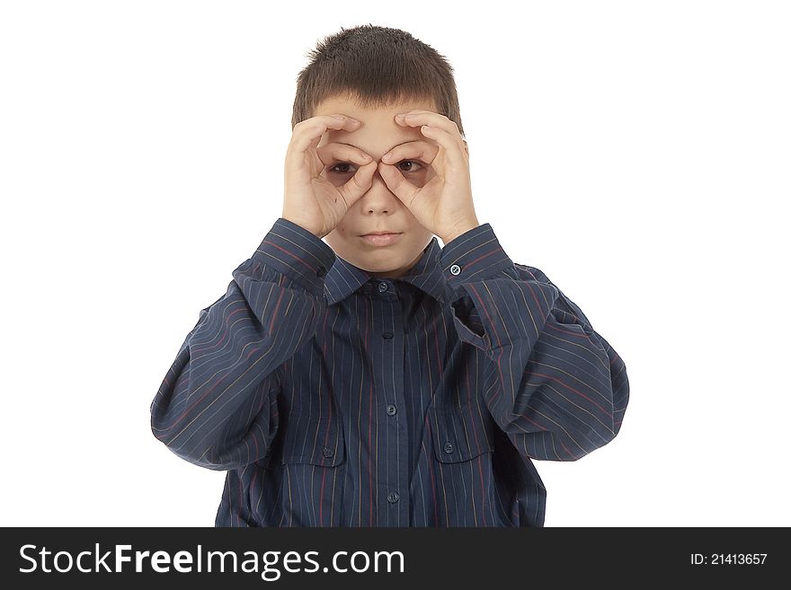 The young eleven-year teenager holds fingers of hands before eyes in the form of points. The young eleven-year teenager holds fingers of hands before eyes in the form of points