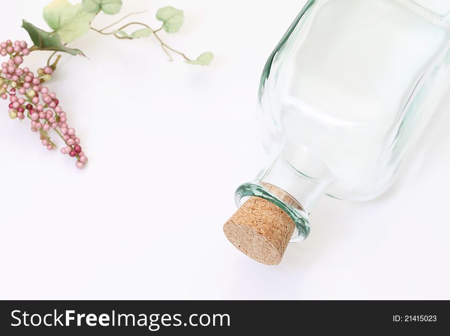 Glass bottle and grapes, on white background