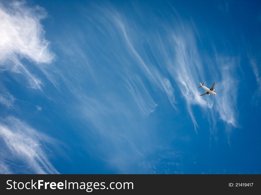 Flying airplane in the blue sky. Flying airplane in the blue sky