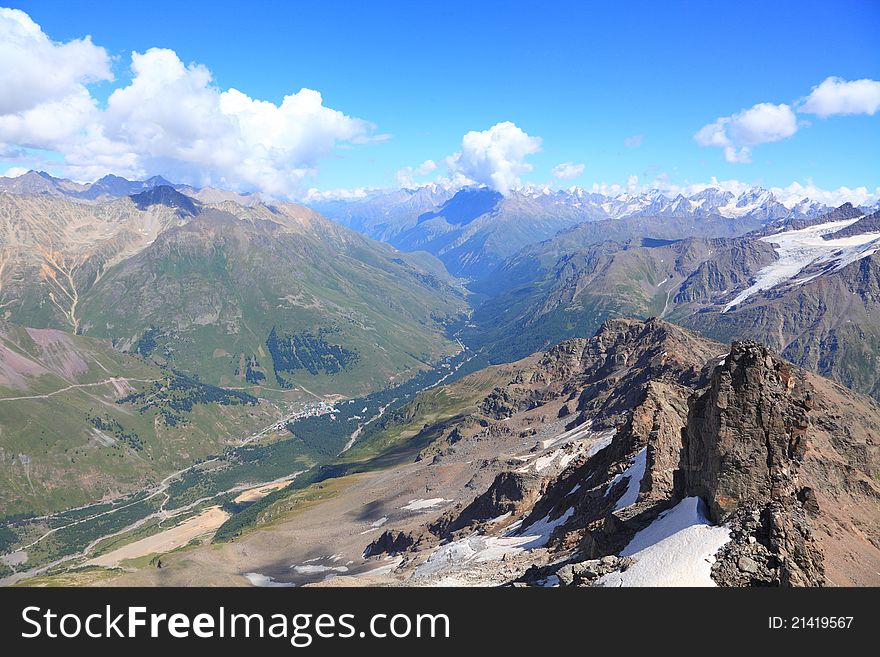 View of main Caucasus ridge and Baksan gorge from the top of mount Cheget in summer. View of main Caucasus ridge and Baksan gorge from the top of mount Cheget in summer