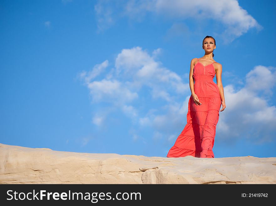 Beauty Woman In Red Dress On The Desert