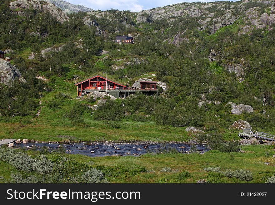 Wooden house beside the river in the mountains