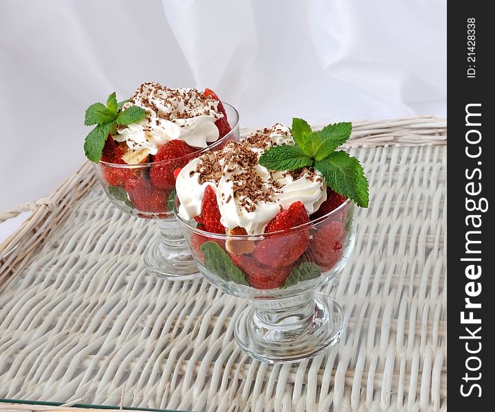 Strawberries with biscuit pieces with mint whipped cream with a grated chocolate