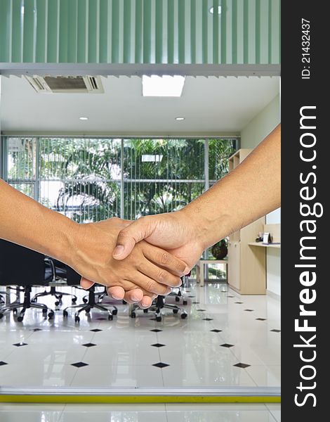 Business handshake with meeting room background, greeting or agreement concept