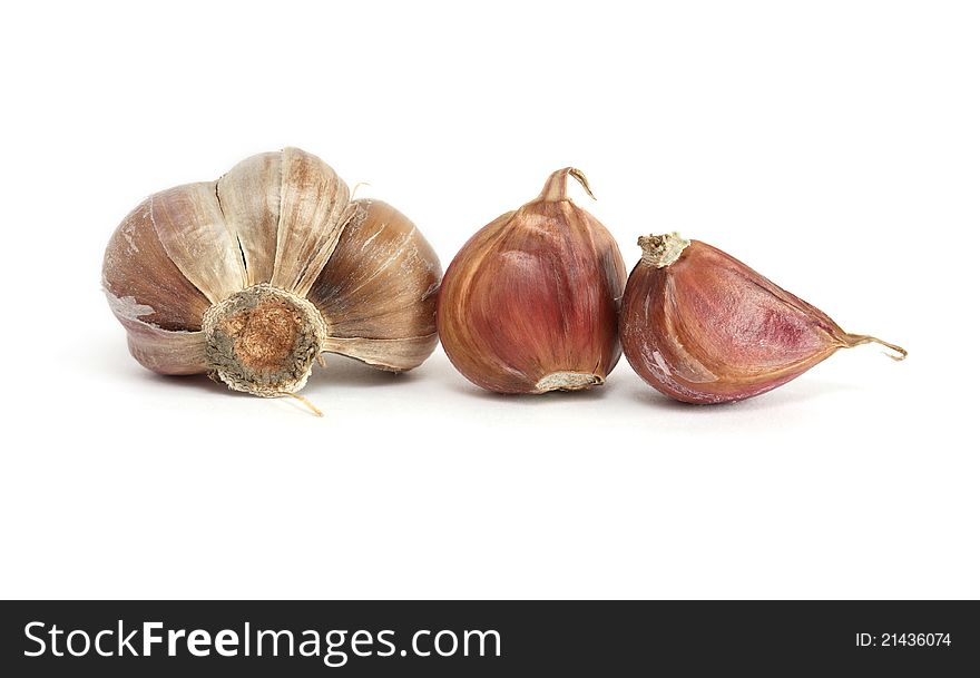 Few cloves of garlic on white background