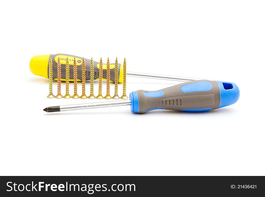 Screwdrivers and row of yellow screws on white background