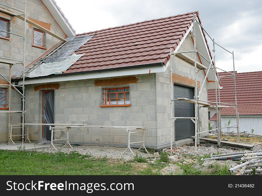 Home with a scaffold to the plaster. Home with a scaffold to the plaster