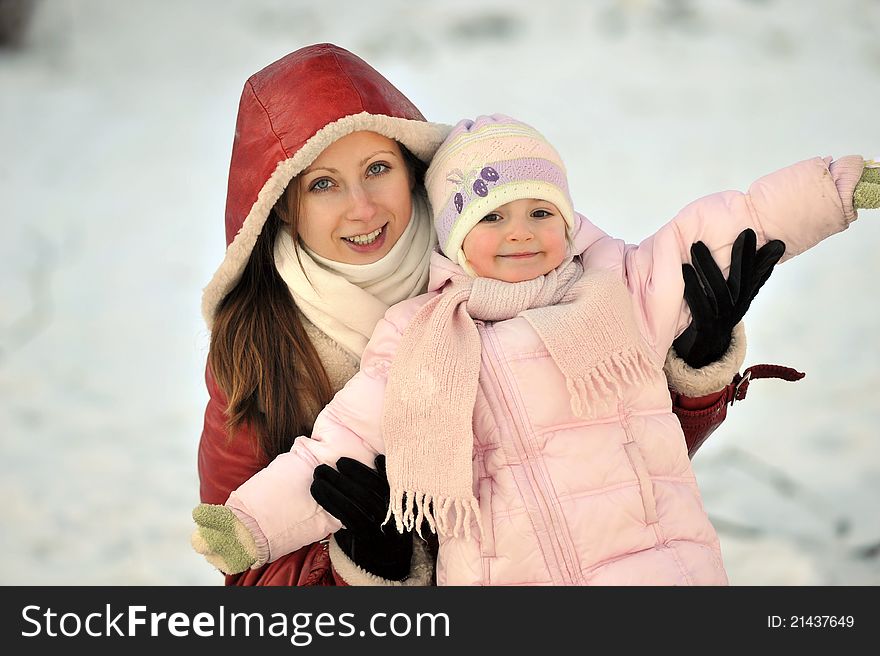 Young mother with her daughter. winter day. Young mother with her daughter. winter day