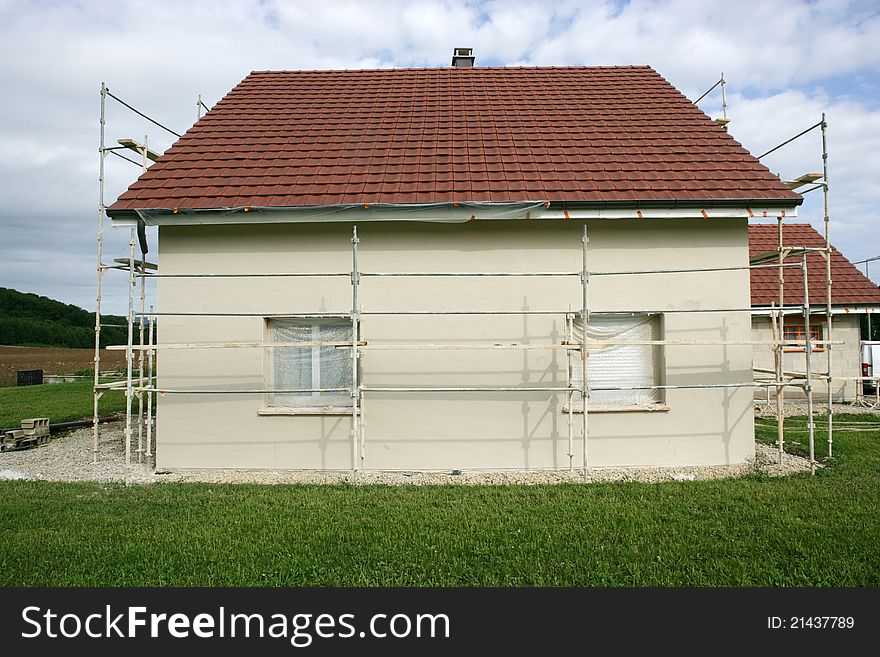 Home with a scaffold to the plaster. Home with a scaffold to the plaster