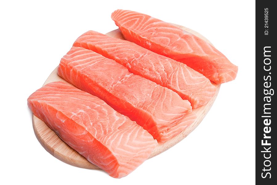 Five slices of fresh salmon on cutting board