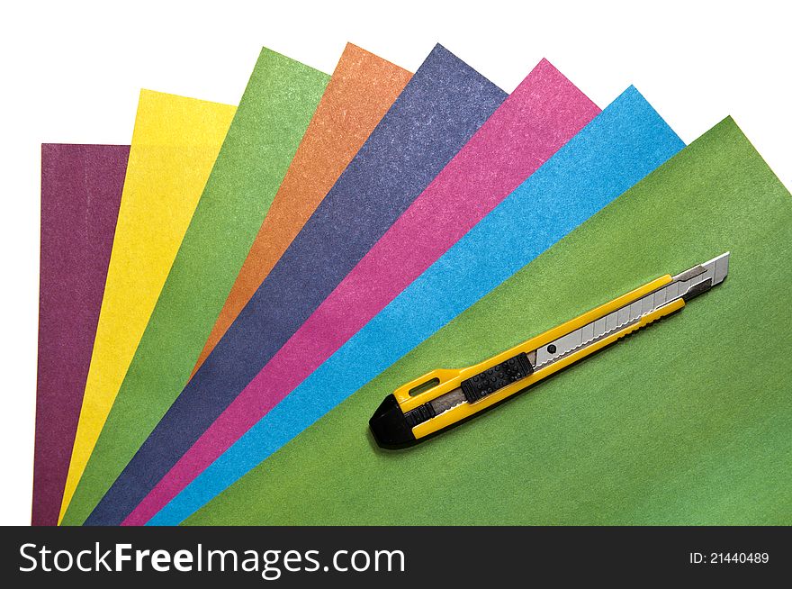 Knife for a paper on sheets of a color paper on white background