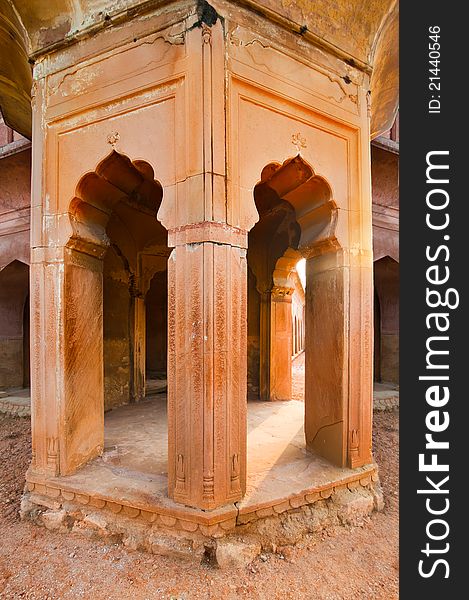 Part of ancient architecture ruins. Columns with arches constructed from terracotta stones. Part of ancient architecture ruins. Columns with arches constructed from terracotta stones