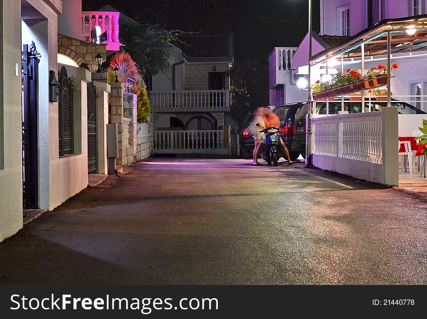 Night road with greased people, cars, buildings and trees. Night road with greased people, cars, buildings and trees.