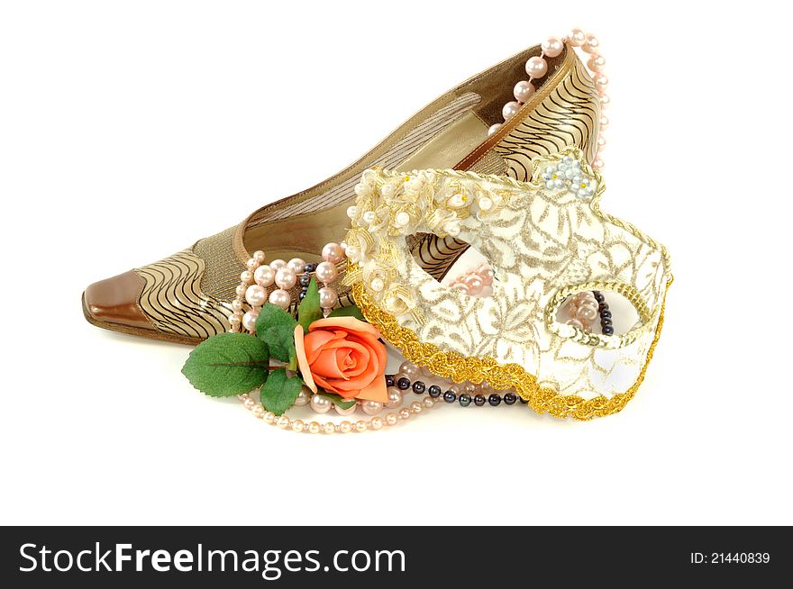 Woman golden shoe with carnival mask   on a white background. Woman golden shoe with carnival mask   on a white background
