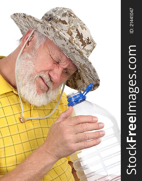 Senior balding bearded man examining empty plastic bottle. Senior balding bearded man examining empty plastic bottle