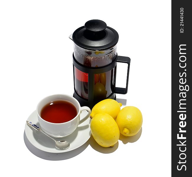 Cup of tea, kettle and three lemons isolated on white