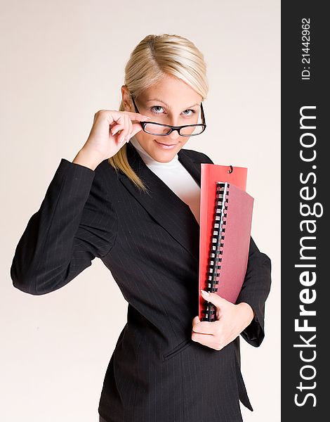 Portrait of beautiful friendly smiling businesswoman peeking over her glasses. Portrait of beautiful friendly smiling businesswoman peeking over her glasses.