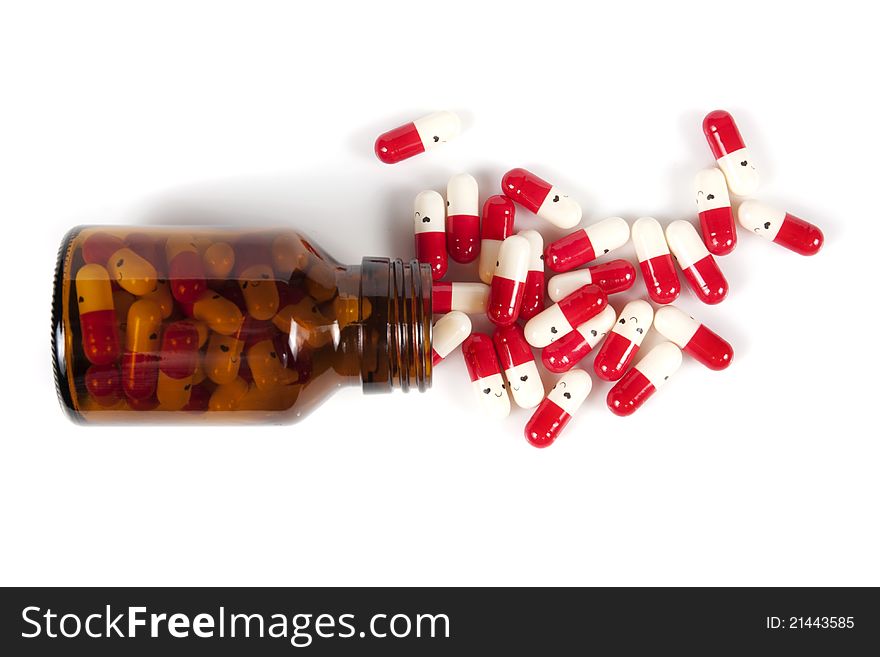 Open happy pill bottle with medicine spilling out of it on white
