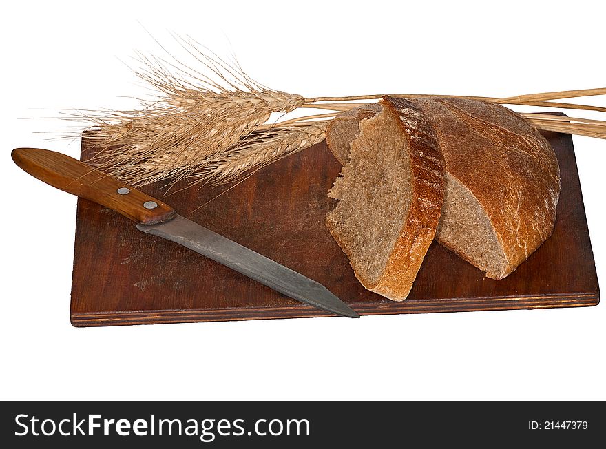 Bread and ears of wheat on white background