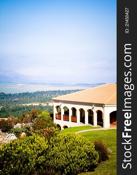 A spanish style summer villa with landscape of mountains and ocean in the distance. A spanish style summer villa with landscape of mountains and ocean in the distance