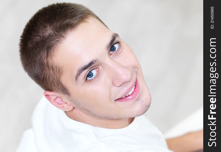 Portrait of smiling young beautiful man at home - high angle. Portrait of smiling young beautiful man at home - high angle