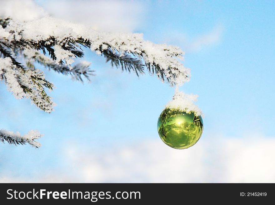 Christmas toy in the snow on a tree branch. Christmas toy in the snow on a tree branch