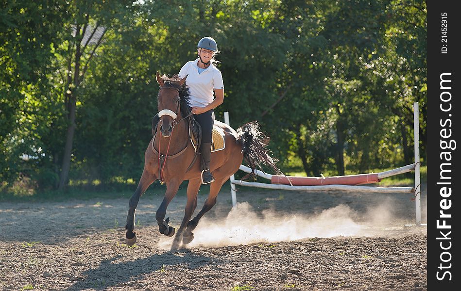 Show jumping.girl riding horse and jumping