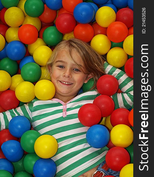 Young girl in colorful balls. Young girl in colorful balls