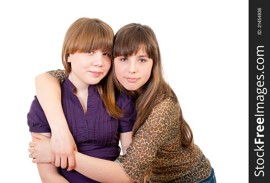 Portrait of two lovely embracing sisters isolated. Portrait of two lovely embracing sisters isolated