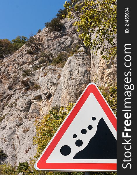 Road sign waring about falling stones, rocks, landslide. Road sign waring about falling stones, rocks, landslide