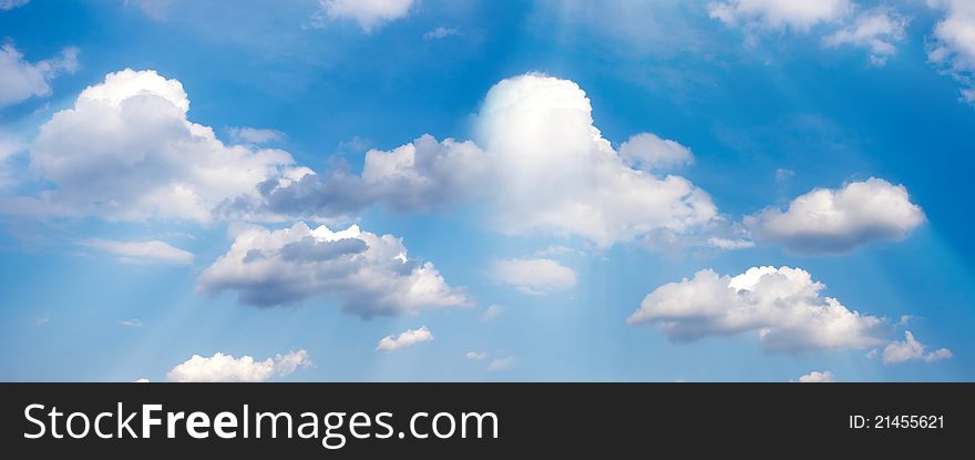 Peaceful background - beatiful blue sky, white clouds, sun beams, light from above