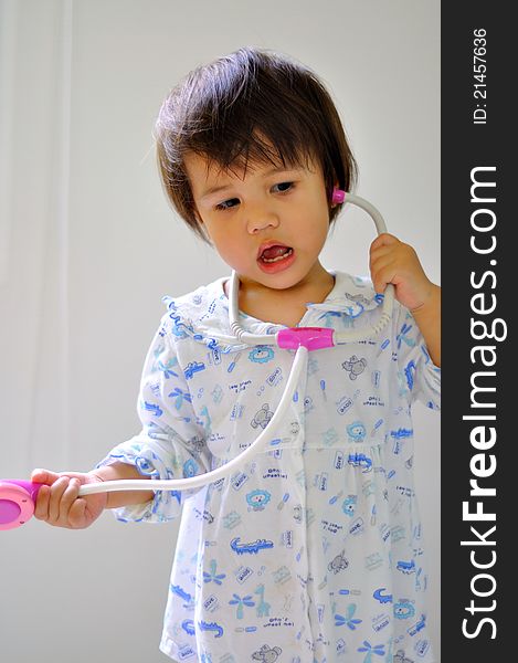 Portrait cute kid with stethoscope toy