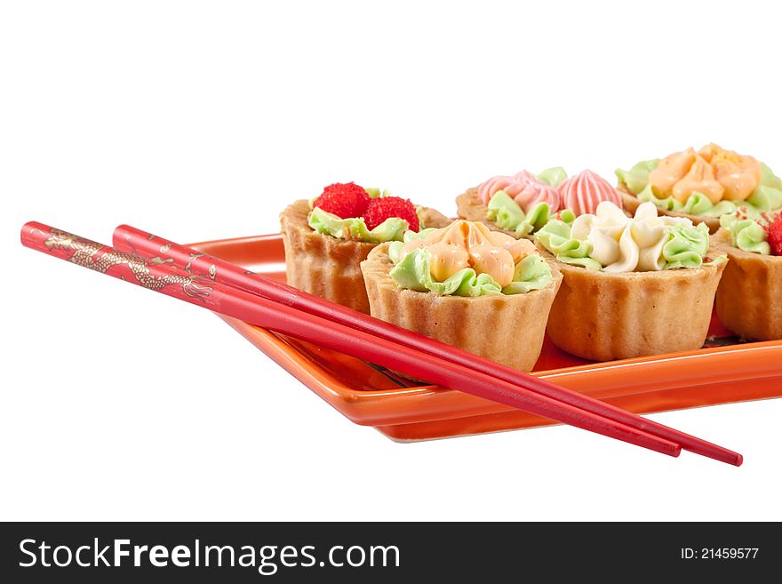 Tasty Cakes And Pair Of Chopsticks Isolated